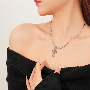 Silver cross pendant necklace with zircon pin chain on woman neck