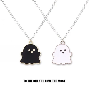 Matching black and white ghost couple necklaces with heart detail on fine silver chains