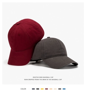Detail of burgundy and dark grey cotton twill 6-panel baseball caps with curved brims