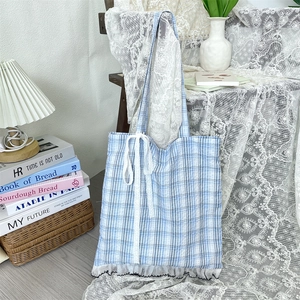 Detailed blue plaid tote bag featuring delicate white lace trim and bow accents