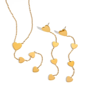 Elegant gold heart pendant necklace and earring set on a clean white background