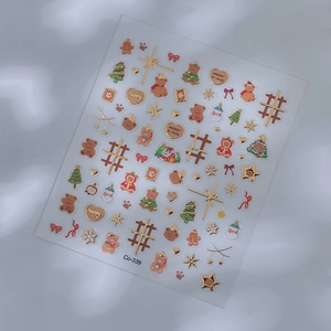 Detailed view of 5D embossed Christmas nail stickers with gold foil trees and bears