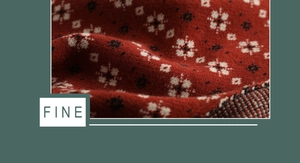 Close-up of soft red knitted fabric with white star patterns and fine wool texture