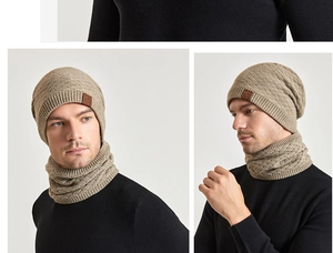 Detail of beige knit beanie and neck gaiter set with leather logo and diamond pattern
