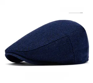 Detailed view of navy blue herringbone tweed flat cap with refined wool blend texture