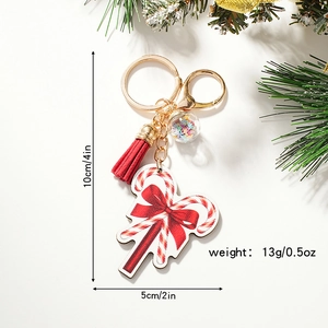 Christmas candy cane keychain with red tassel and colorful star glass ball on white background