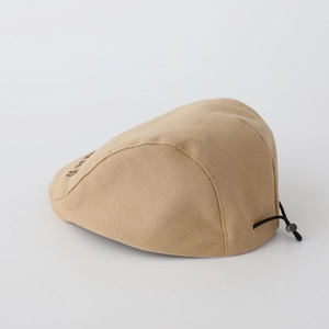 Close-up of khaki cotton beret with bear embroidery and adjustable black toggle