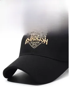 Macro detail of the 1949 yellow embroidery on the black cotton canvas baseball cap