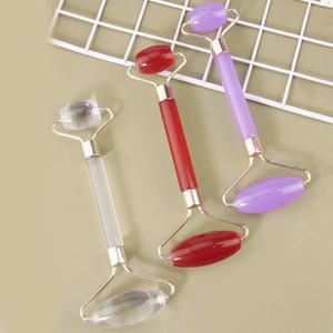 Close-up of dual-head resin face rollers in clear, red, and purple with metal frames