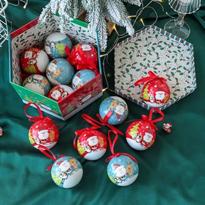 Christmas ornament balls with Santa and reindeer patterns in a festive gift box