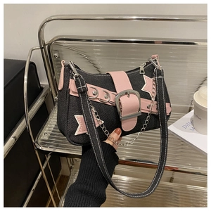 Detail of Y2K denim star bag featuring pink leather accents and silver metal chains