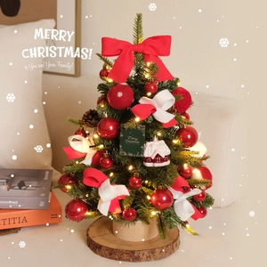 Mini DIY Christmas tree with red bows, pine cones, and LED lights on a wooden base