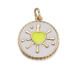 Detail of a round gold-plated pendant with a green heart and radiant sunburst rays