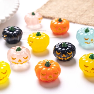 Assorted colorful resin Halloween pumpkin figurines with classic Jack-o'-lantern faces