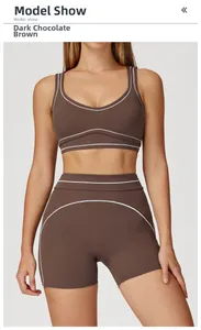 Detail of the high-waist yoga shorts with white contrast piping in dark chocolate brown