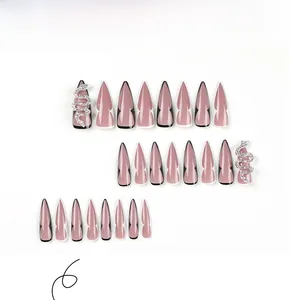 Detail of pink almond press on nails featuring silver snake rhinestones and line art