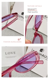 Detail of pink transparent cat-eye sunglasses with metal hinges and purple tinted lenses