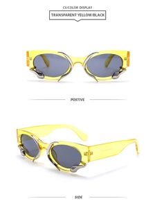 Detail view of transparent yellow snake sunglasses with silver metal flame accents