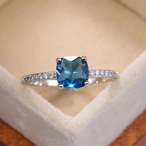 Classic silver-tone ring with square blue sapphire zircon and pavé setting on the band