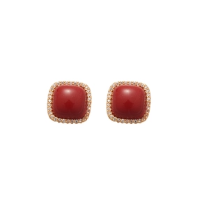 Elegant gold earrings with square red zircon stones and small diamonds on white background