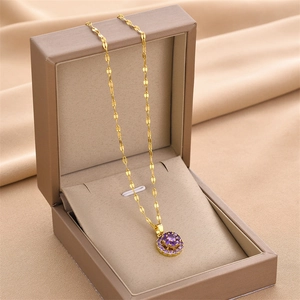Gold-plated titanium steel necklace featuring a circular pendant with purple gemstones