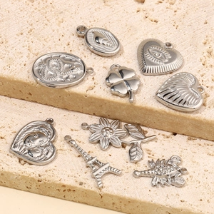Set of 9 assorted silver stainless steel charms including heart and clover on stone