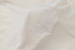 Macro shot of semi-transparent white mesh fabric showing lightweight breathable texture