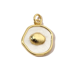 Macro shot of circular gold shell pendant with white textured enamel finish and ring
