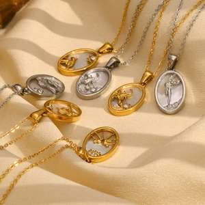 Detail of 18K gold and silver plated oval zodiac pendants with mother of pearl inlay