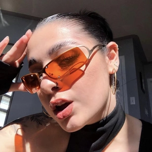 Detail of vintage steampunk sunglasses with orange lenses and a metallic oval frame