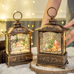 Vintage bronze Christmas lantern with sparkling snow globe and Santa Claus scene
