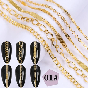 Detail of six assorted gold nail art metal chains on black nails and white background