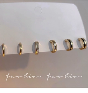 Detailed set of gold plated earrings featuring cubic zirconia and enamel finishes