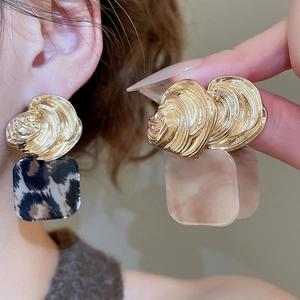 Detail of square earrings featuring acrylic leopard print and marble textures on ear