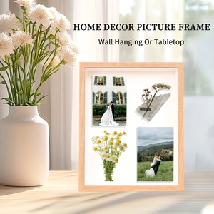 Close-up of a 3D wooden shadow box frame featuring four segments of dried flowers and photos