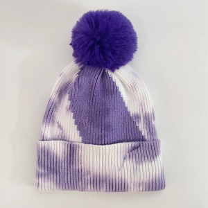Close-up of the ribbed knit texture and purple tie-dye pattern on the beanie with pom