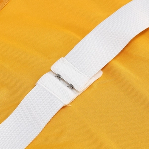 Macro shot of white elastic strap and metal hook detail on a yellow tulle tube dress