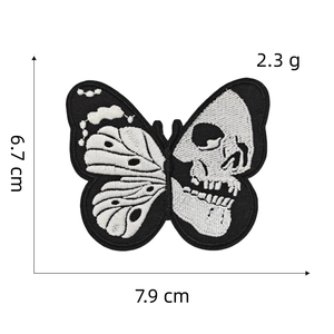 Detailed close-up showing black and white embroidery textures of butterfly skull patch