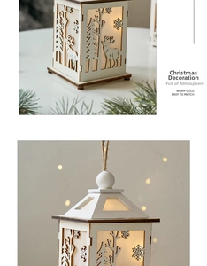 Detail of white wooden Christmas lantern with reindeer cutout and warm glowing light