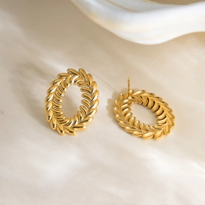 Detail of 18K gold-plated stainless steel leaf earrings with intricate relief texture