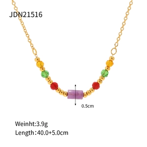 Detail of colorful beaded stainless steel necklace with gold chain and purple bead