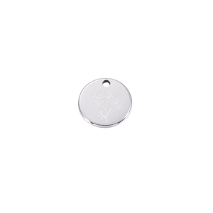 Close-up of a silver stainless steel round pendant with etched floral birthday flower pattern