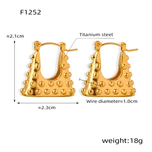 Detailed view of gold titanium steel earrings with dot texture and 2.1x2.3cm dimensions