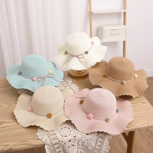 Five kids straw sun hats with wavy edges, colorful pompoms and cute bow details
