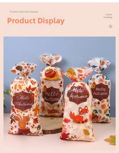 Detailed view of autumn gift bags with squirrel, fox and maple leaf festive prints