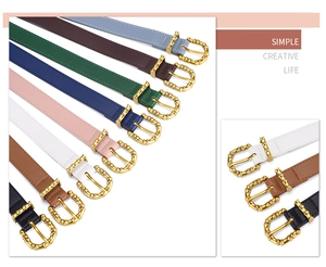 Detail of bamboo gold buckle on colorful PU leather belts for coats and jeans