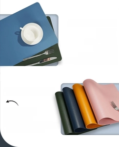 Close-up of stacked colorful waterproof leather placemats showing heat resistant texture