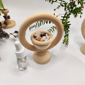 Minimalist wood ring essential oil diffuser with natural stones and a dropper bottle