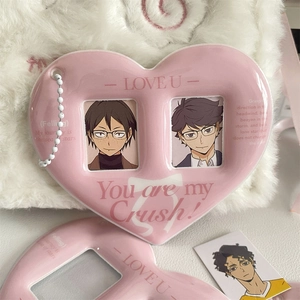 Detailed view of pink heart-shaped card holder with white bead chain and engraved text