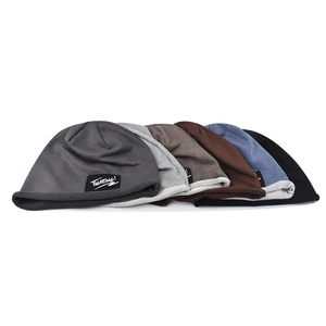 Detail of diverse colors for the knitted beanie with a stylish TIGHTING label